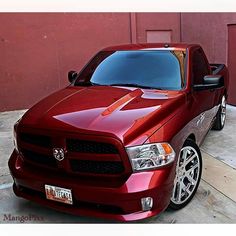 a red truck parked in front of a building