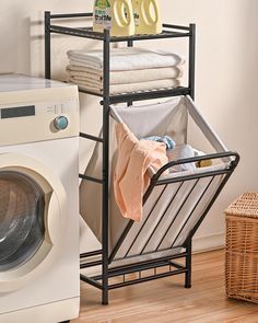 a washing machine and dryer sitting next to each other in front of a laundry basket