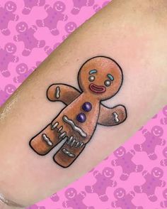 a small tattoo on the leg of a person with a ginger in it's hand