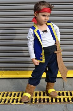 a young boy dressed up as beast from the movie beauty and the beast, standing in front of a garage door