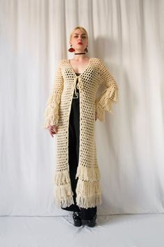 Please zoom on pictures for full resolution :) Hello, This is an amazing and rare handmade fringed crochet coat from the 1970's. -Label: None -Size : please refer to measurements -Fabric : feels like wool -Condition: Very good Measurements: -Bust: 41 cm (82 cm all around) / 32,3 inches all around up to (when stretched): 51 cm (102 cm all around) / 40,1 inches all around -waist: 39 cm (78 cm all around) / 30,7 inches all around up to (when stretched): 53 cm all around (106 cm all around) / 41,7 i Crochet Fringe Jacket, Hippie Crochet Cardigan, Bohemian Beige Outerwear With Tassels, Long Beige Bohemian Outerwear, Beige Bohemian Long Outerwear, Bohemian Long Outerwear With Tassels, Long Bohemian Outerwear With Fringe, Long Bohemian Outerwear With Tassels, Bohemian Long Fringe Outerwear