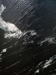 an aerial view of the ocean with waves