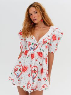 Ti amo, Daisy Mae! This v-neck red mini dress is printed with a whimsical, '90s Italian-inspired heart and cherries print, designed to capture the essence of Italian summers. Featuring puff sleeves, ruched cups, and a gathered skirt, this mini sundress is finished with an embroidered eyelet collar, trims, and a lace bow at the center-front. Heart Print Dress, Daisy Mae, Mini Dress White, Mini Sundress, Lemon Dress, Cherry Print, Lace Bows, Gathered Skirt, Love And Lemons