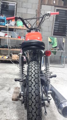 an old motorcycle is parked in a garage