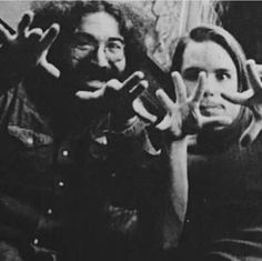 black and white photo of two people with their hands in the shape of peace signs