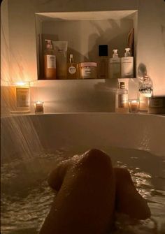 a bathtub filled with lots of bottles and candles