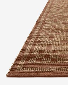 a brown and white rug on top of a wooden floor