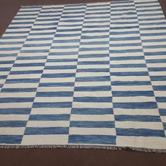 a blue and white checkered rug on the floor