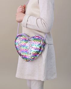 Carrying your belongings doesn't have to be boring, it can actually be magical. This open hear bag is great to take a few things on the go. 7'' W x 6'' H 20'' shoulder strap length Zip closure Spot clean Heart Crossbody Bag, Dorothy Costume, Heart Purse, Sequin Mask, Sequin Purse, Sequin Leggings, Lavender Heart, Twirly Dress, Rainbow Tutu