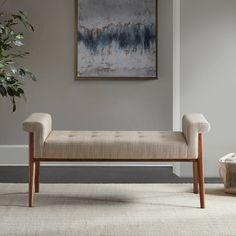 a bench sitting in front of a painting on the wall