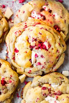 cranberry white chocolate chip cookies are piled on top of each other and ready to be eaten