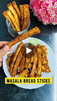 masala bread sticks on a plate with flowers in the background