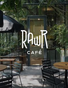 an outdoor cafe with tables, chairs and umbrellas