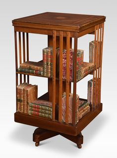 a wooden book shelf with books on it's sides and two shelves filled with books