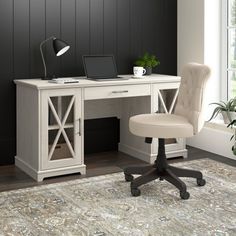 a white desk with a laptop on it and a chair in front of the desk