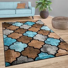 a living room with a blue couch and brown rug