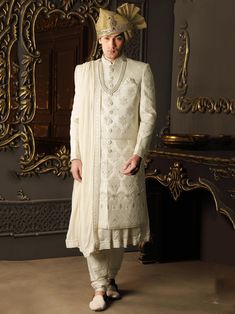 White Color sherwani crafted in silk gives you the touch of royalty and gentleness.Modernised with thread embroidery and Hand work.This sherwani go with white churidar,anarkali kurta and embroidered stole,each item is handcrafted with silk.Wearing such Sherwani makes a noble and ethical glimpse of yourself. Groom Sherwani,Traditional Indian mens clothing,indian wedding attire for men,designer sherwani for men. NOTE:Cost Includes Stitched Sherwani,Kurta,Stole & Matching Pyjama Designer Sherwani For Men, Traditional Indian Mens Clothing, Off White Anarkali, Sherwani For Groom, Groom Sherwani, White Anarkali, Sherwani For Men Wedding, Embroidered Sherwani, Groom Dress Men