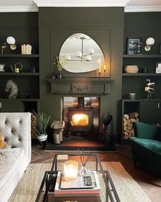 a living room filled with furniture and a fire place next to a mirror on the wall