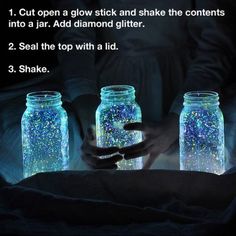 three mason jars filled with blue and white glitters, one is holding the jar