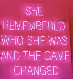 a neon sign that says she remembers who she was and the game changed