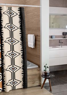 a bathroom with a bathtub, sink and shower curtain in the middle of it