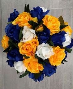 a bouquet of yellow and blue flowers on a table