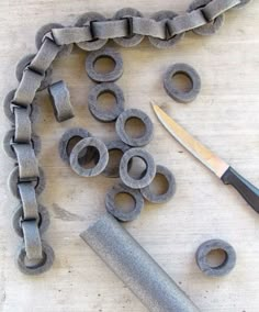 an image of some metal parts on a table with a pair of scissors and a knife