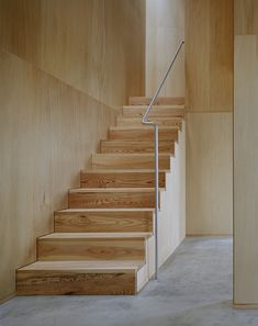 the stairs are made of wood and have metal handrails