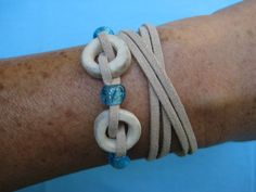 a person's arm with two bracelets on it and one has a blue bead