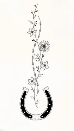 a black and white drawing of a flower with a horseshoe hanging from it's side