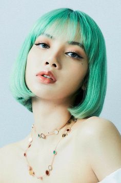 a woman with green hair wearing a necklace