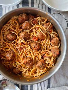 spaghetti with meatballs and sauce in a pan