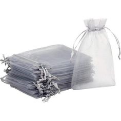 a bag filled with lots of gray paper next to a pile of grey napkins