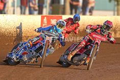 two motorcyclists racing on the dirt track