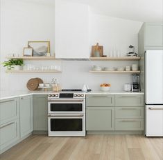 a white stove top oven sitting inside of a kitchen