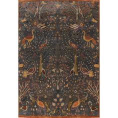 an antique rug with birds and flowers on it, in dark blue tones is shown