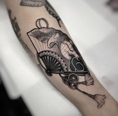 a black and white photo of a tattoo on the arm