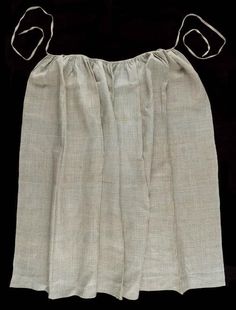 an old white skirt with two metal clips on the bottom and one in the middle