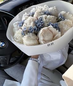 a bouquet of flowers is sitting in the driver's seat of a car