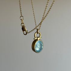 Icy inclusions shimmer beneath the sleek surface of this captivating aquamarine pendant. 18k yellow gold Aquamarine, 2.74ct, 8mm x 10mm (5/16" x 3/8") Chain is 16" long Modern Yellow Gold Aquamarine Jewelry, Modern Aquamarine Yellow Gold Jewelry, Gold Blue Topaz Jewelry With Polished Finish, Formal Yellow Gold Aquamarine Necklace, Gold Aquamarine Pendant Necklace, Aquamarine Pendant, Newport Ri, Oval Table, Newport