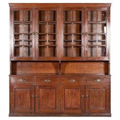 an old wooden china cabinet with glass doors