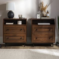 two wooden dressers sitting next to each other on top of a carpeted floor