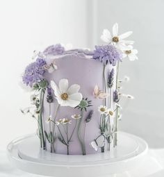 a white cake with purple and white flowers on it