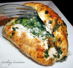 a chicken breast stuffed with pepper jack cheese and spinach is being cut into pieces