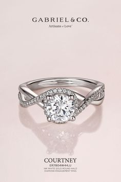 In this 14K white gold engagement ring, a diamond encrusted criss cross band leads into bedazzling diamond halo center stone.  
14K White Gold Round Halo Diamond Engagement Ring
ER7804W44JJ Criss Cross Engagement Ring, White Gold Engagement Ring