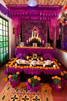 a decorated altar with candles and flowers