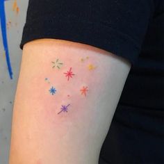 a woman's arm with stars on it