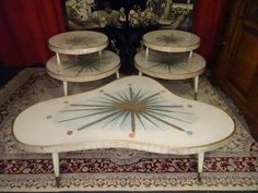 three tables sitting on top of a rug in front of a mirror