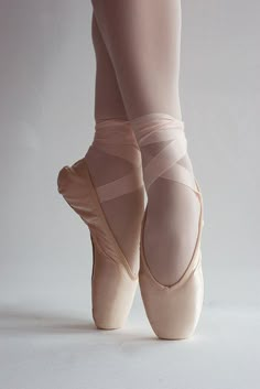 the feet of a ballerina in pink ballet shoes with text that reads, dance