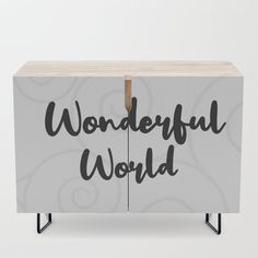 a white cabinet with the words wonderful world on it's doors and black legs